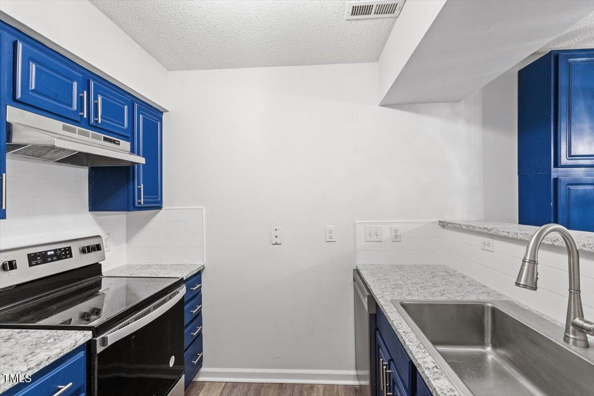 3307 Tarleton West, Unit A4 Durham, NC 27713 - Photo 25 of 40 a kitchen that has a sink and a stove