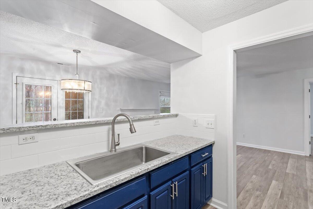 3307 Tarleton West, Unit A4 Durham, NC 27713 - Photo 27 of 40 a kitchen with a sink and cabinets
