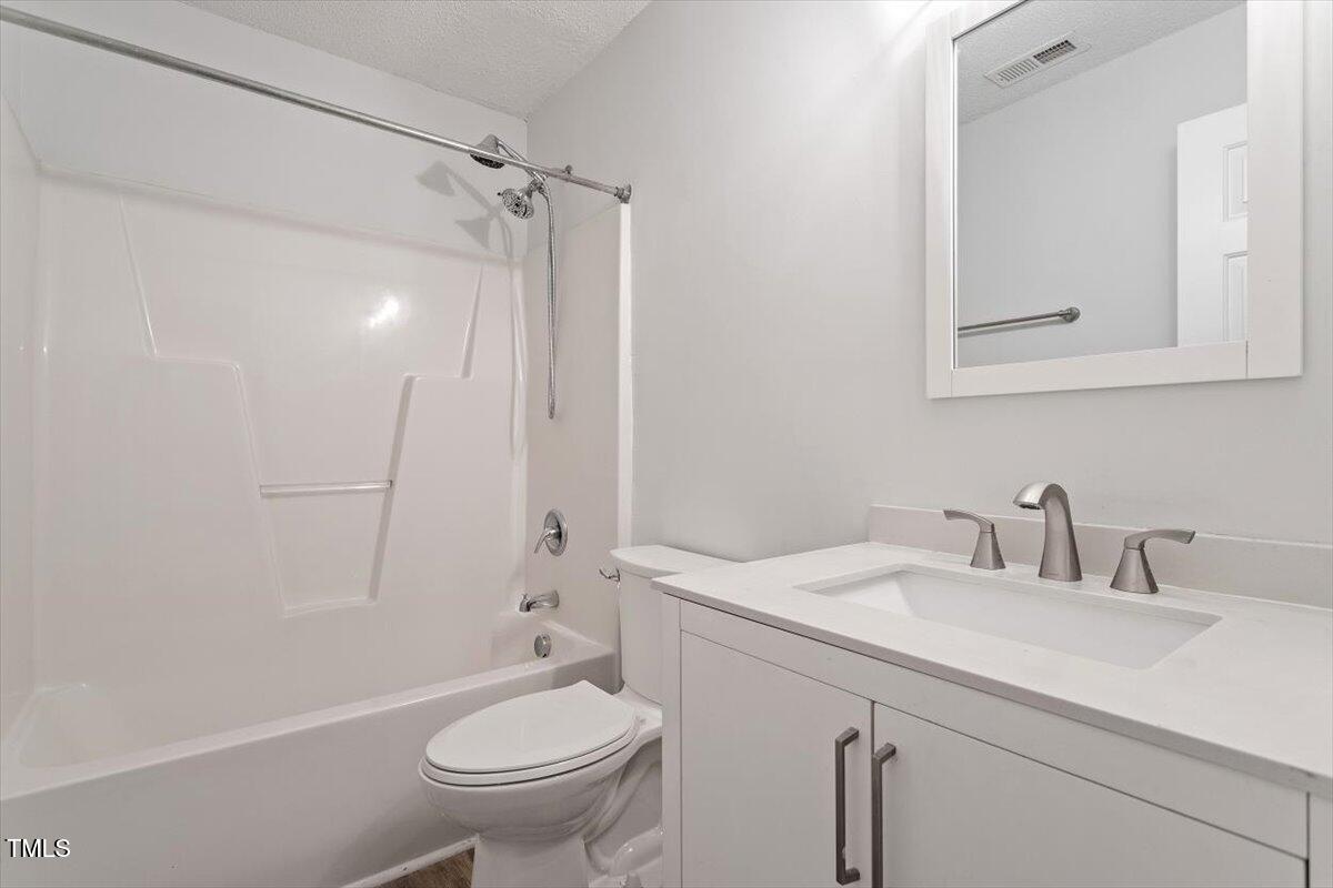 3307 Tarleton West, Unit A4 Durham, NC 27713 - Photo 31 of 40 a bathroom with a sink a toilet and a mirror