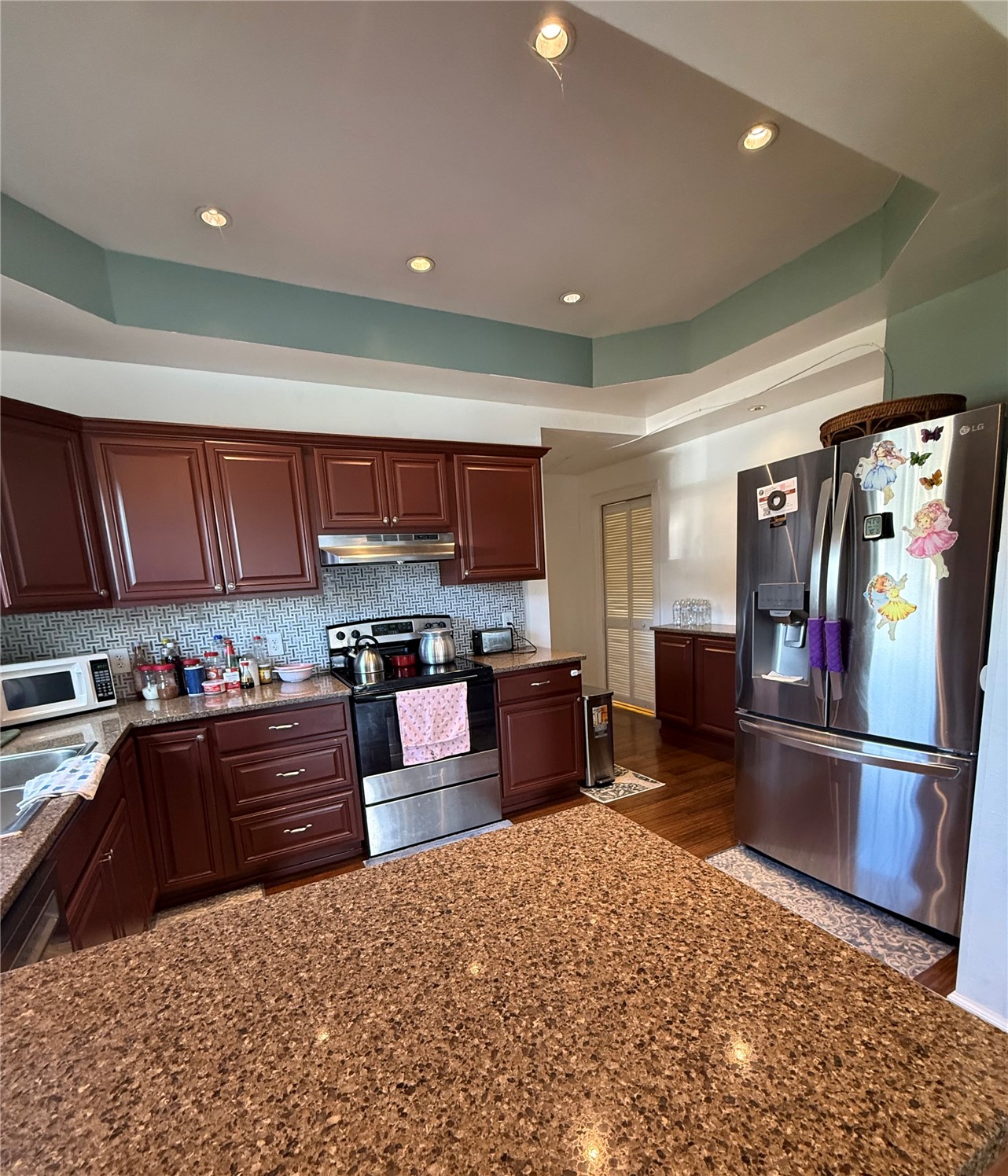 1919 Riddell Street Raymond, WA 98577 - Photo 6 of 25 a kitchen with stainless steel appliances granite countertop a refrigerator stove top oven and sink
