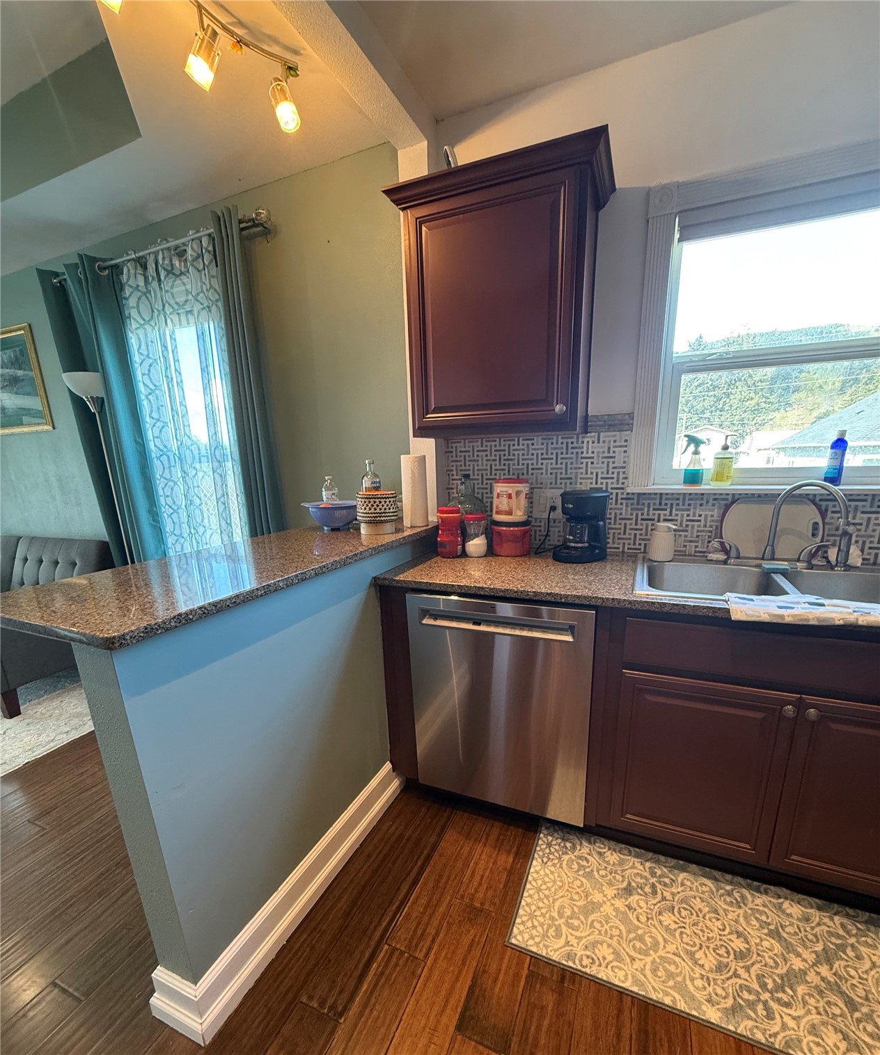 1919 Riddell Street Raymond, WA 98577 - Photo 7 of 25 a kitchen with stainless steel appliances granite countertop a sink a stove a microwave a counter space and cabinets
