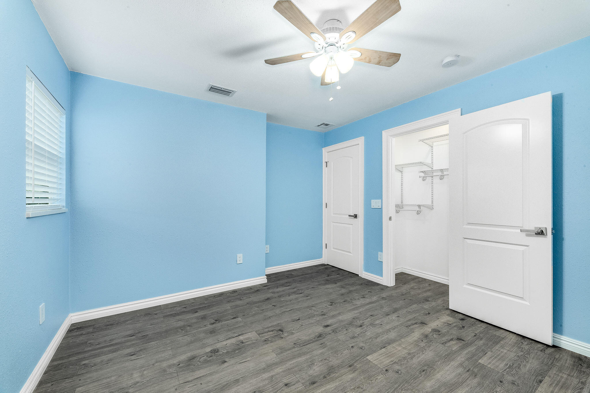 411 4th Street Merritt Island, FL 32953 - Photo 18 of 26 an empty room with wooden floor and ceiling fan