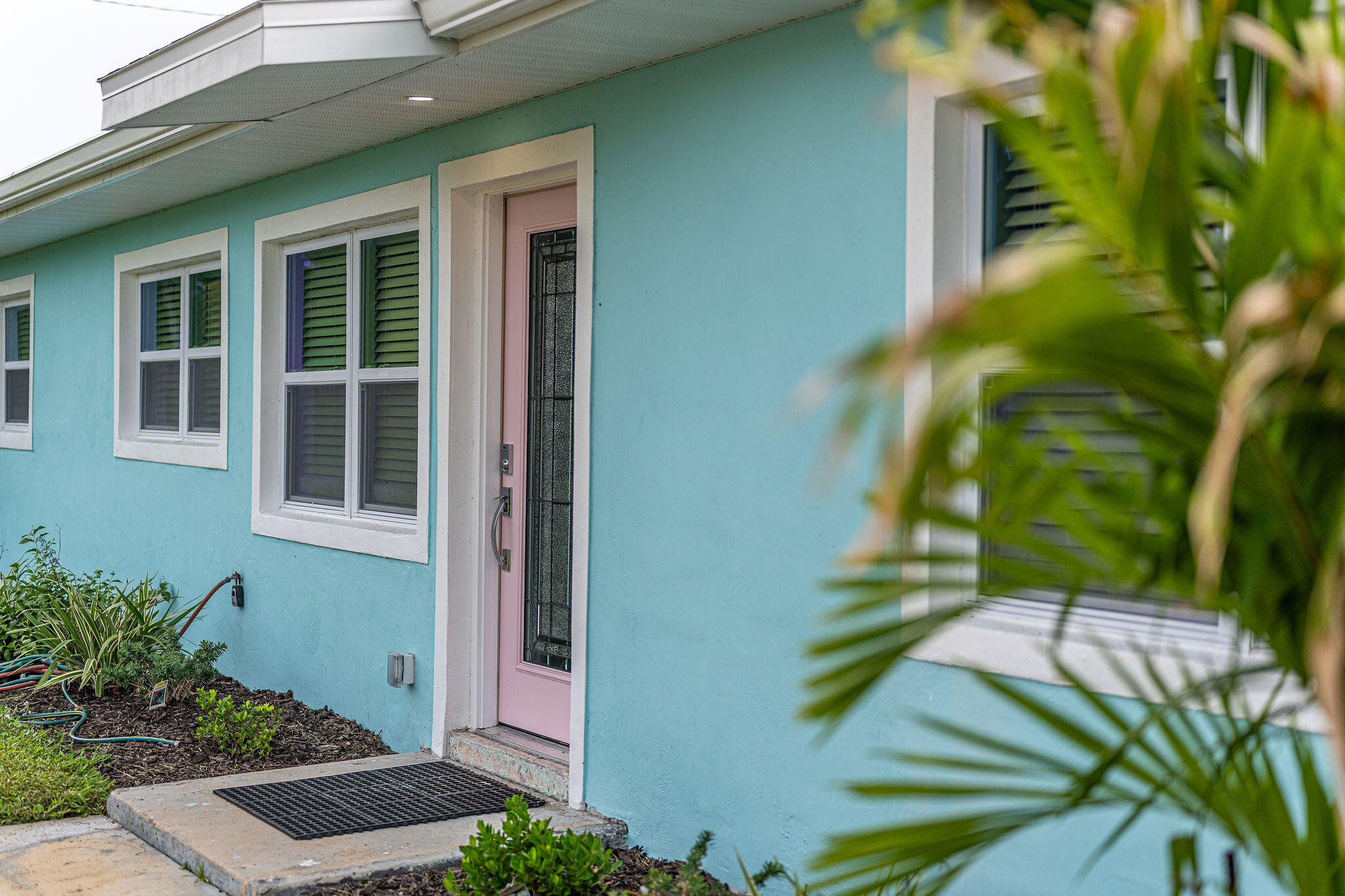 411 4th Street Merritt Island, FL 32953 - Photo 25 of 26 a view of backyard with potted plants and floor to ceiling window