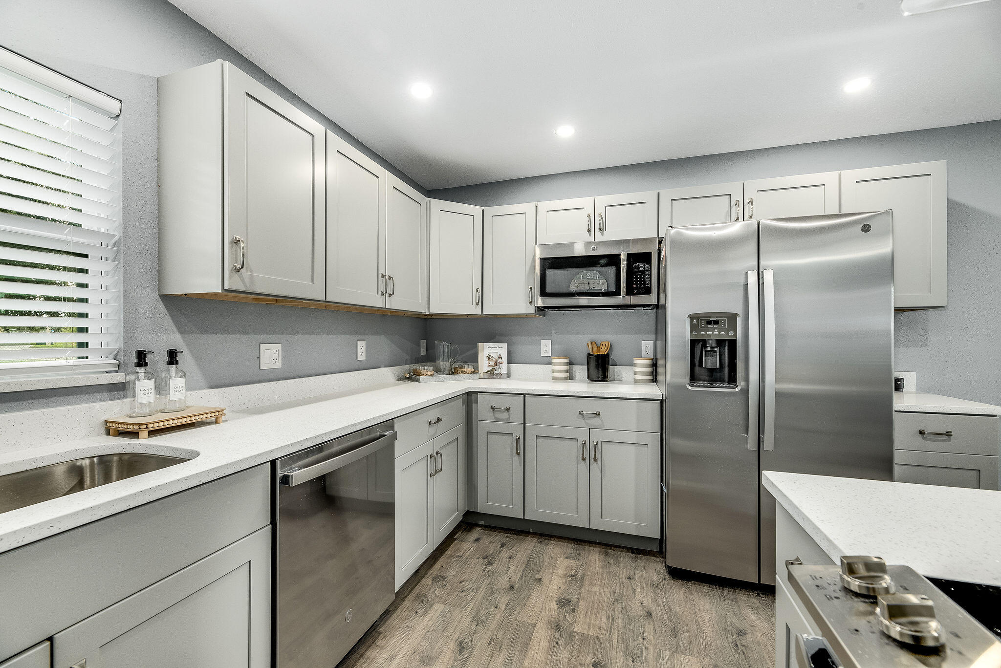 411 4th Street Merritt Island, FL 32953 - Photo 6 of 26 a kitchen with a sink stove and refrigerator