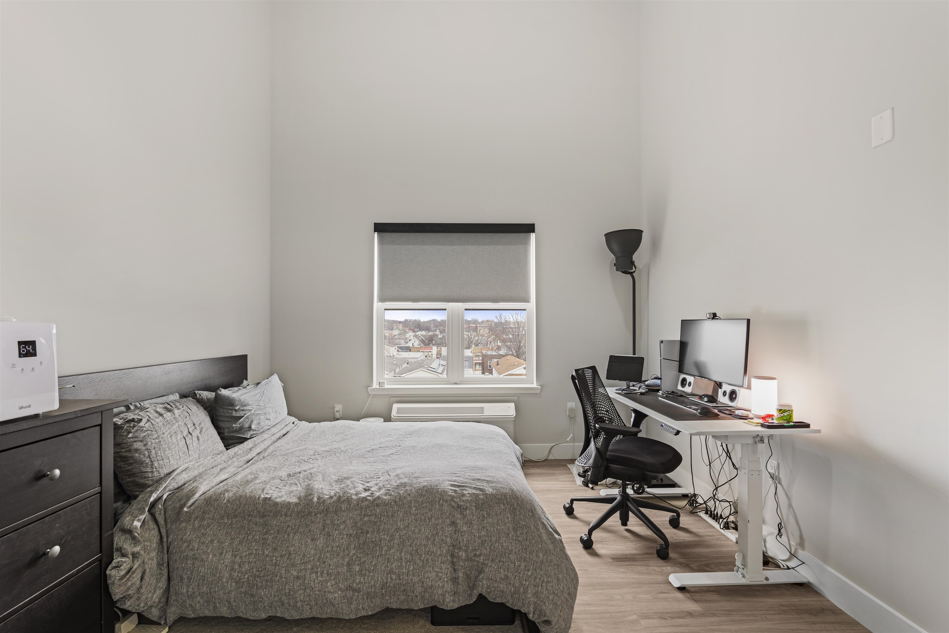 212 70th Street, Unit 404 Guttenberg, NJ 07093 - Photo 11 of 14 a bedroom with a bed a desk and chair with window