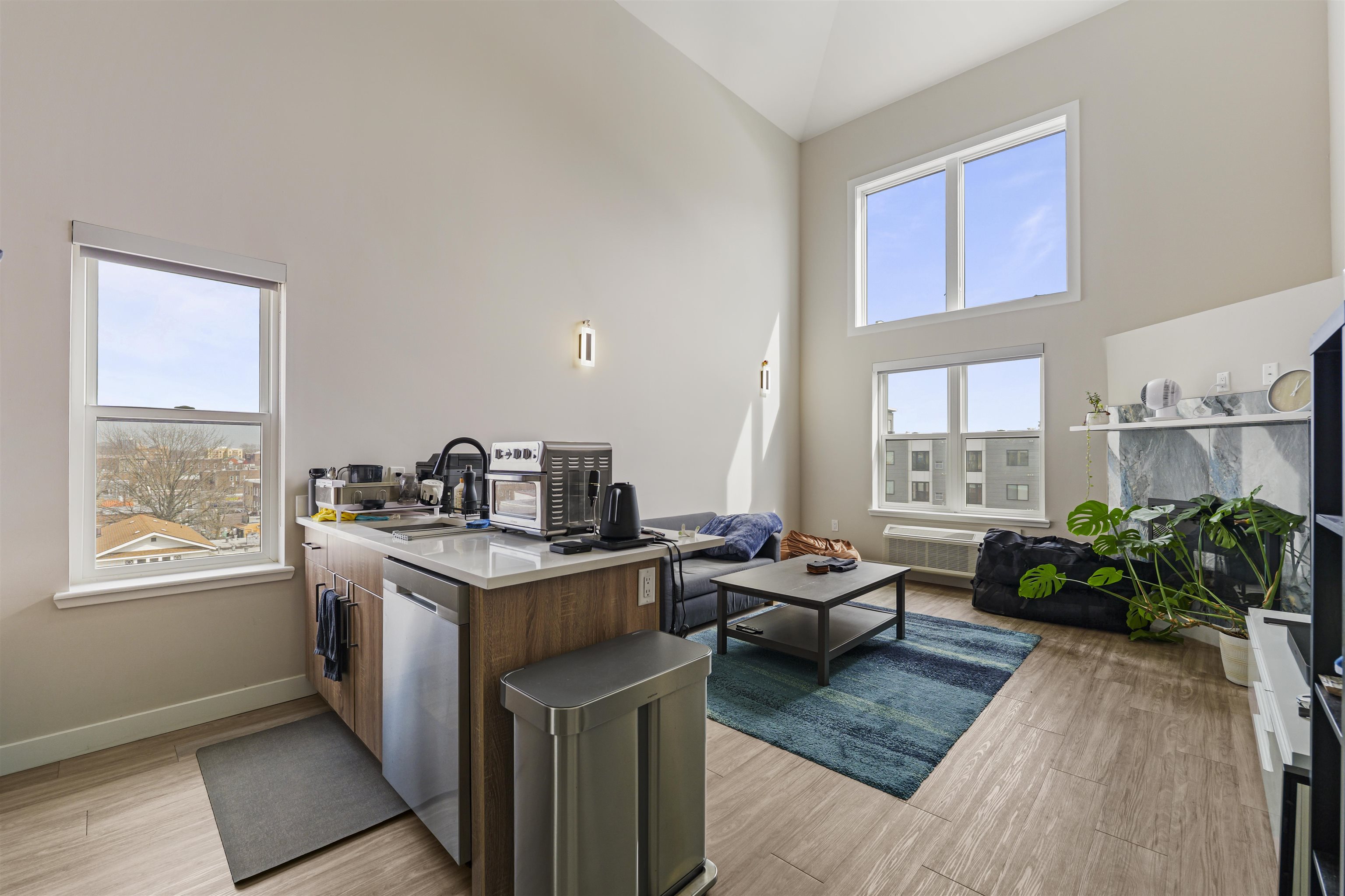 212 70th Street, Unit 404 Guttenberg, NJ 07093 - Photo 2 of 14 a living room with furniture kitchen and a window
