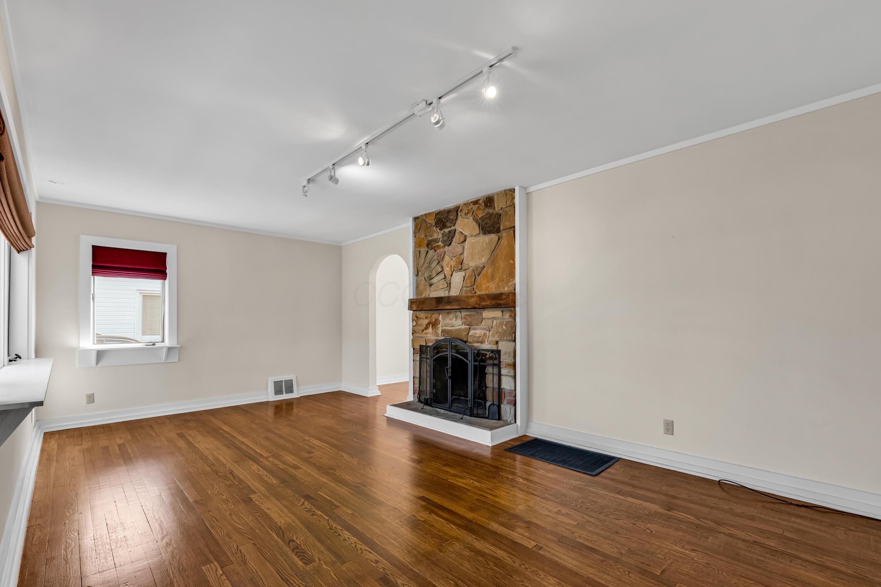 2033 Zollinger Road Columbus, OH 43221 - Photo 9 of 44 • Hardwood flooring
• Ivory painted walls
• Track lighting
• Woodburning, stone
fireplace with mantle