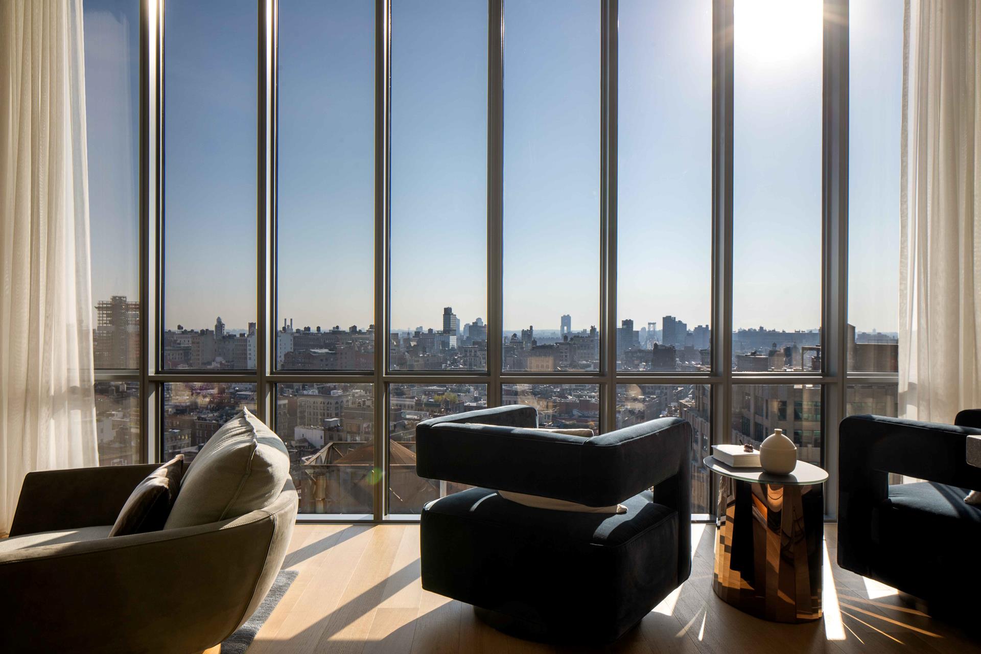 a living room with furniture city view and ocean view
