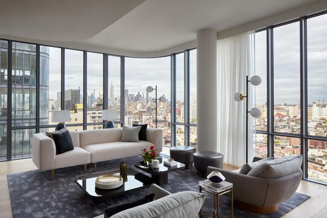 a living room with furniture and floor to ceiling windows