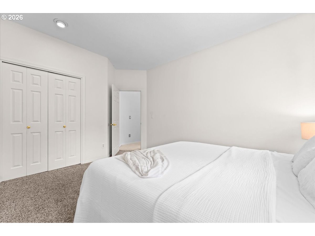 12431 Southwest 55th Place Portland, OR 97219 - Photo 18 of 40 a bedroom with a bed and a painting