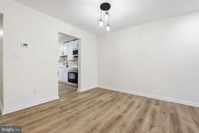 a view of a kitchen with wooden floor and a sink