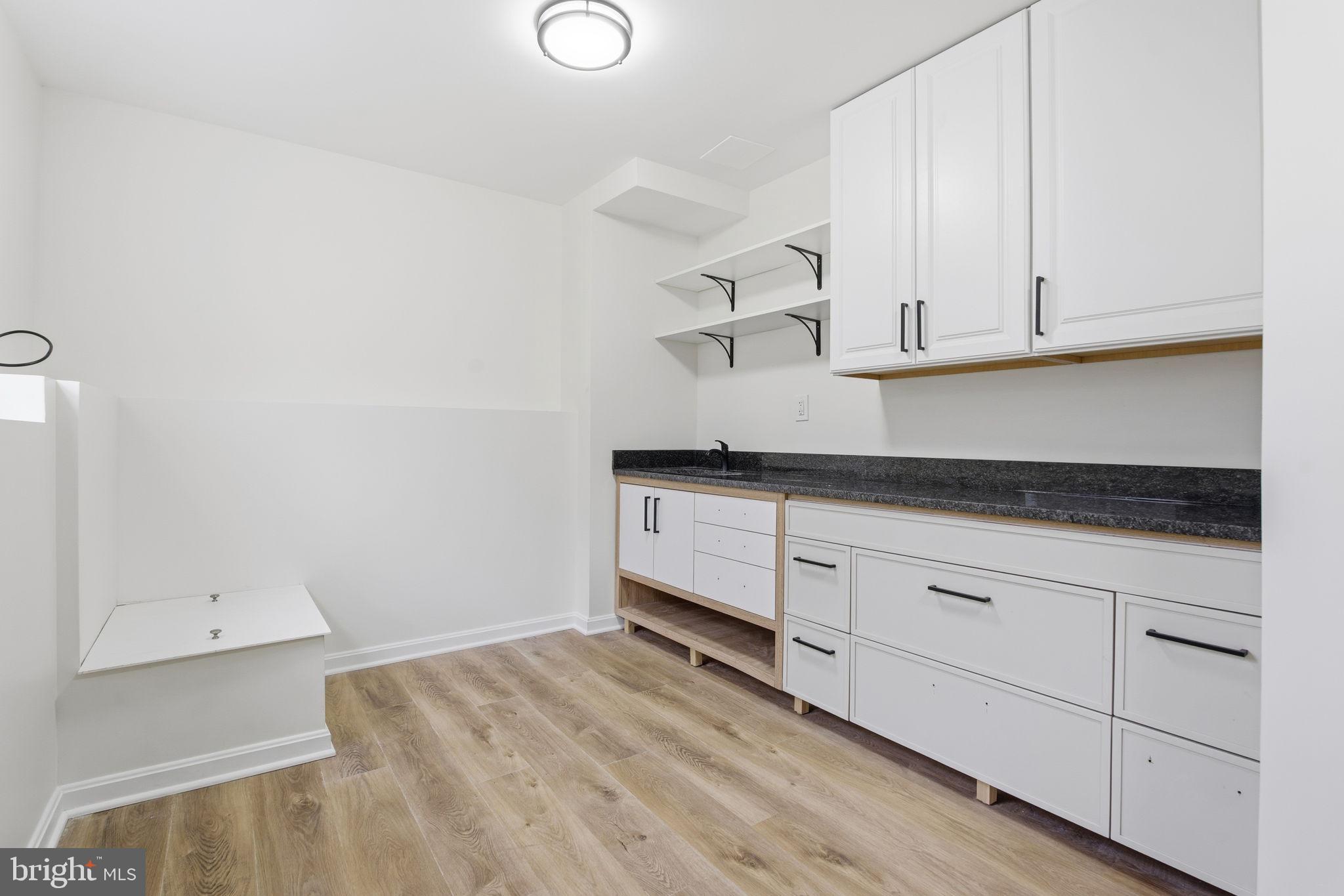 629 Nollmeyer Road Middle River, MD 21220 - Photo 29 of 35 a kitchen with granite countertop white cabinets and a sink