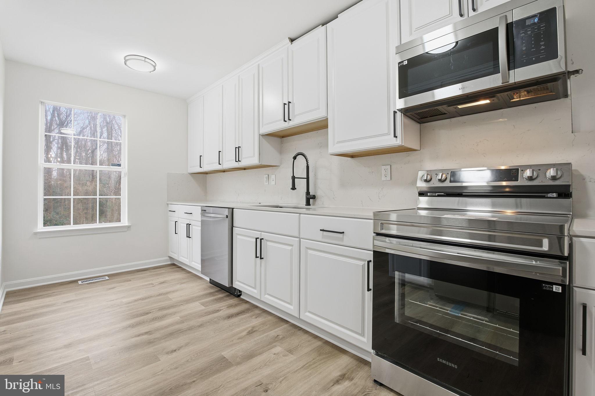 629 Nollmeyer Road Middle River, MD 21220 - Photo 3 of 35 a kitchen with stainless steel appliances granite countertop a stove and a microwave