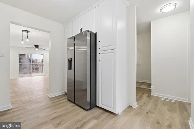 a view of a refrigerator in kitchen and wooden floor