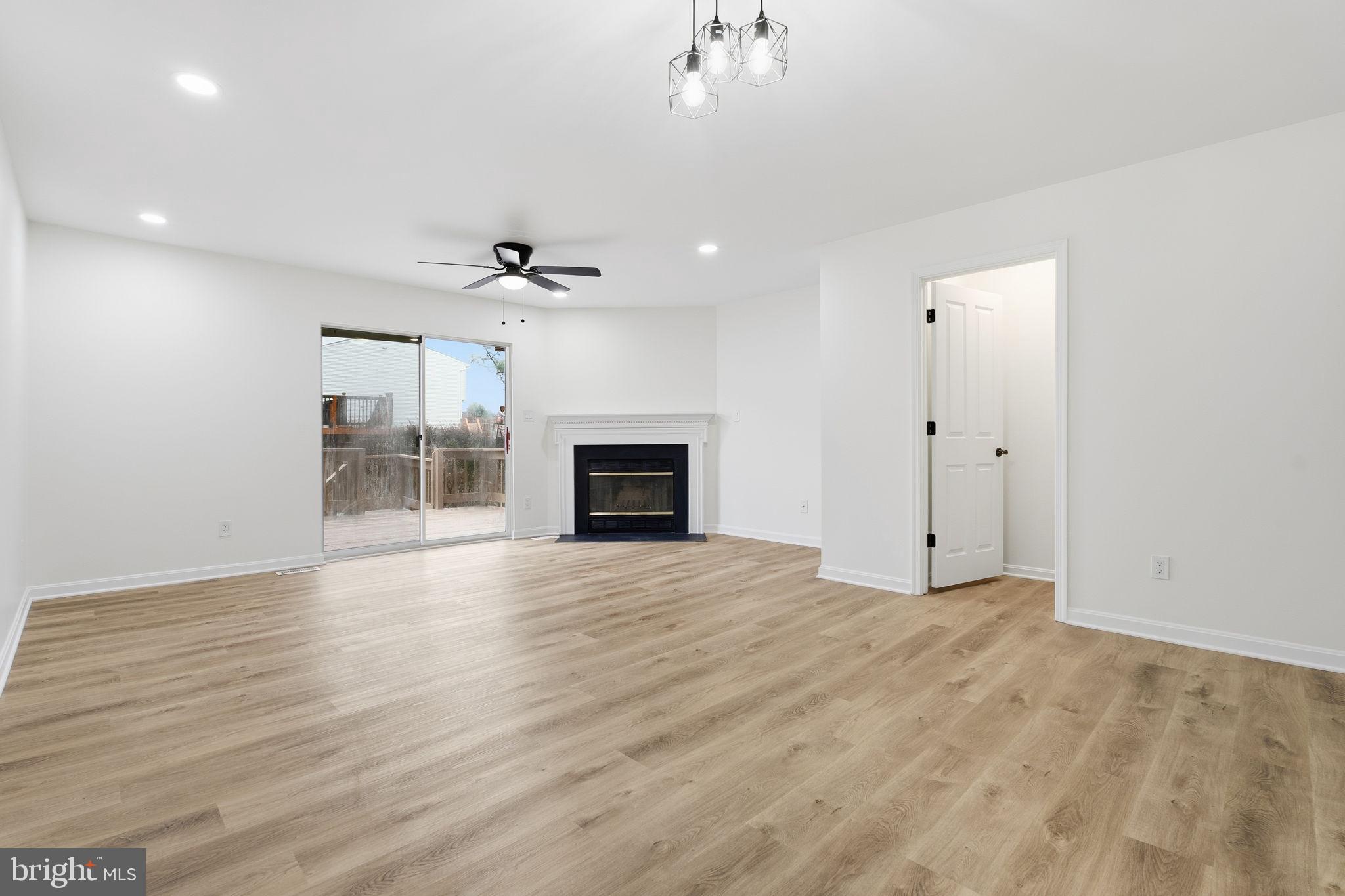 629 Nollmeyer Road Middle River, MD 21220 - Photo 7 of 35 an empty room with wooden floor and ceiling fan