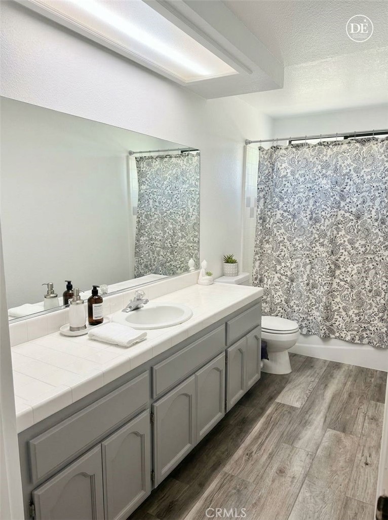 13375 Rincon Road Apple Valley, CA 92308 - Photo 33 of 72 a bathroom with a double vanity sink toilet and a mirror