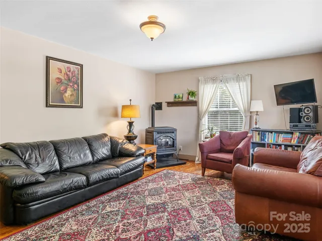 a living room with furniture a couch and a flat screen tv