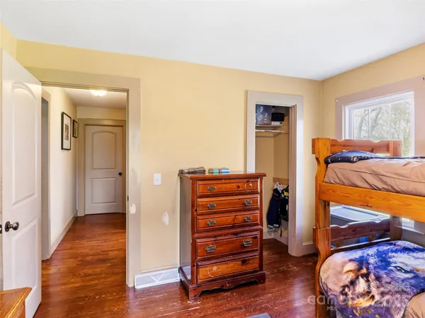 a view of room with wooden floor and closet