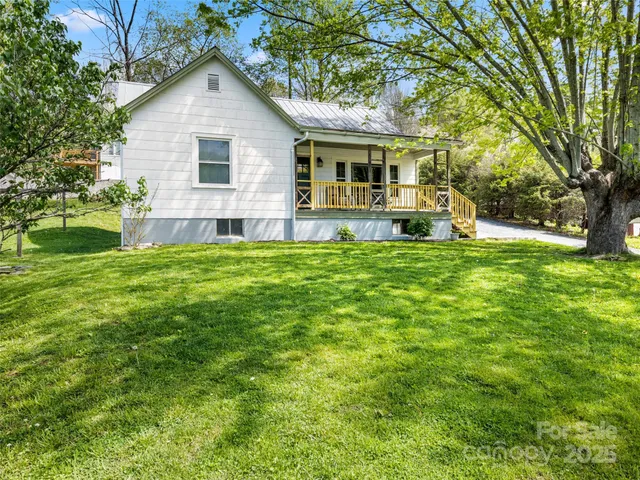 a view of a house with a yard