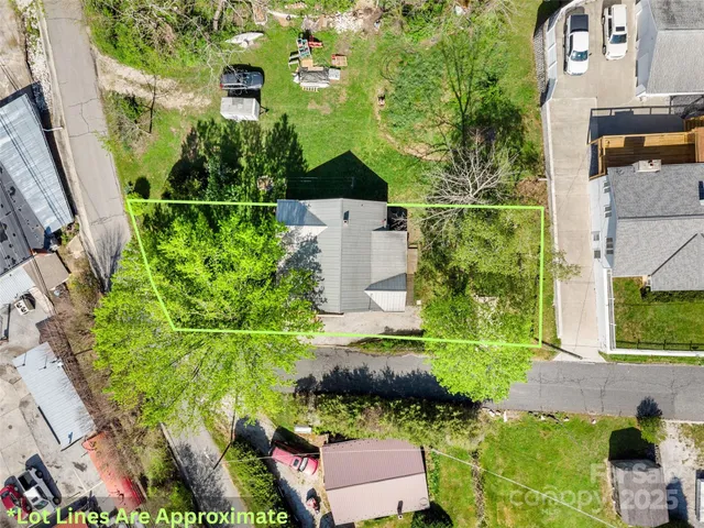 an aerial view of a house with pool outdoor seating and yard