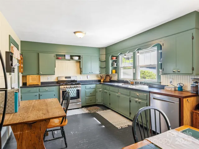 a kitchen with a table chairs sink and cabinets