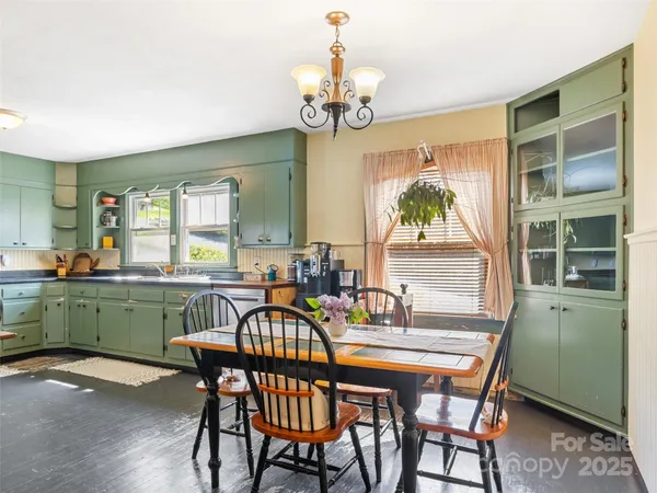 a dining room with furniture a livingroom and chandelier