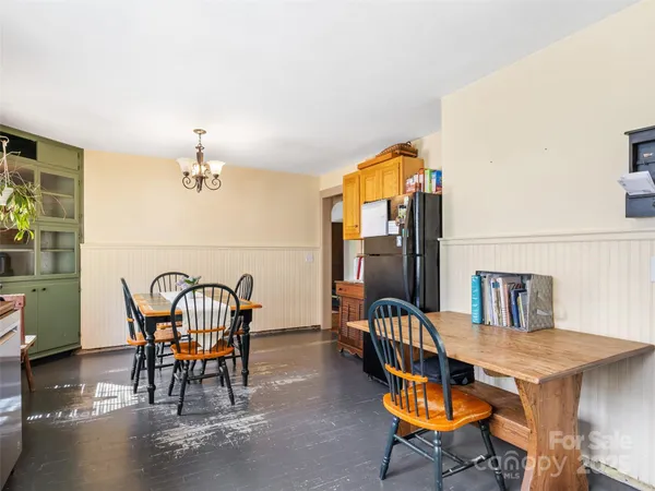 a dining room with furniture and chandelier