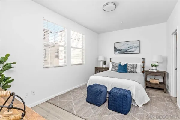 a bedroom with a large bed and a potted plant