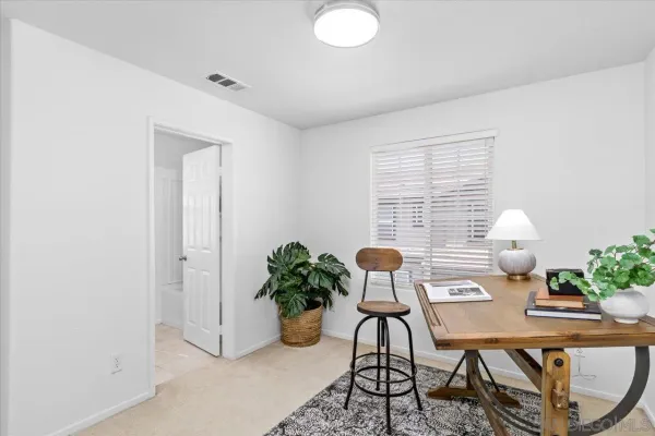 a workspace with furniture and a potted plant