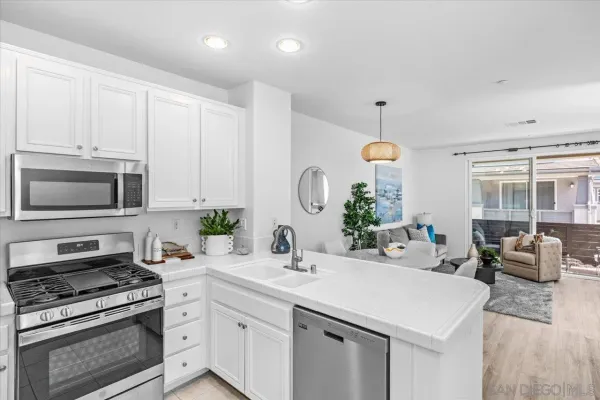 a kitchen with cabinets appliances and a window