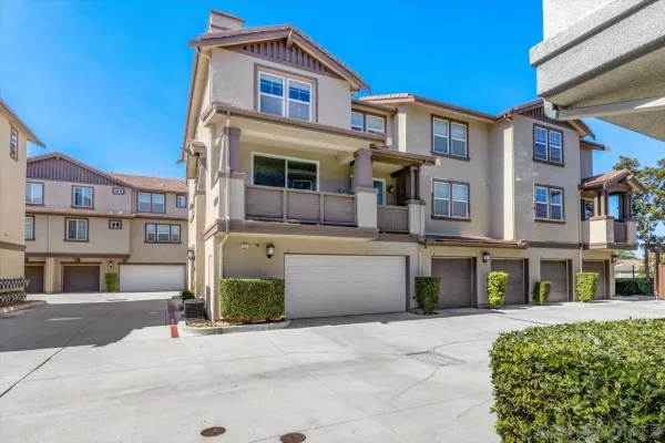 a front view of a residential apartment building with a yard