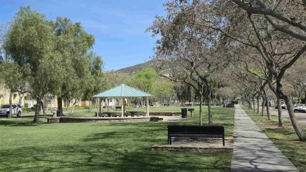 a swimming pool with outdoor seating and a garden
