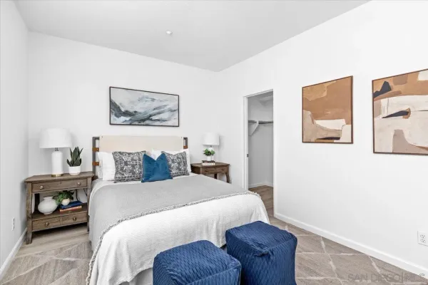 a bedroom with a bed and a painting on the wall