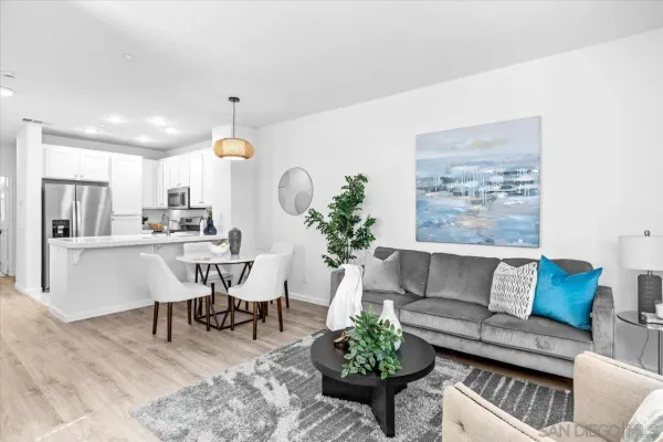 a living room with furniture and a chandelier