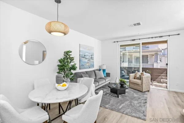 a living room with furniture potted plant and a large window