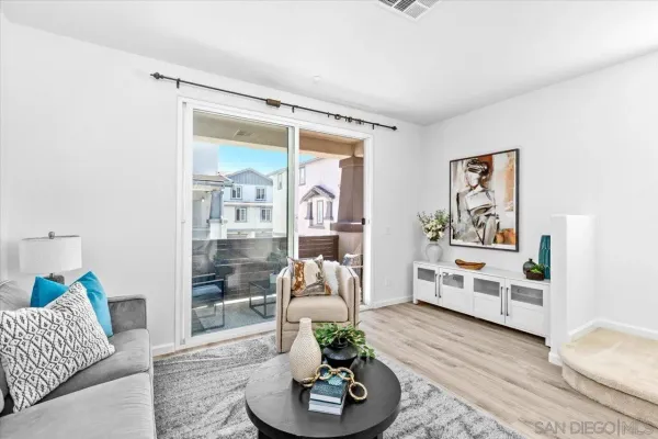 a living room with furniture and a potted plant