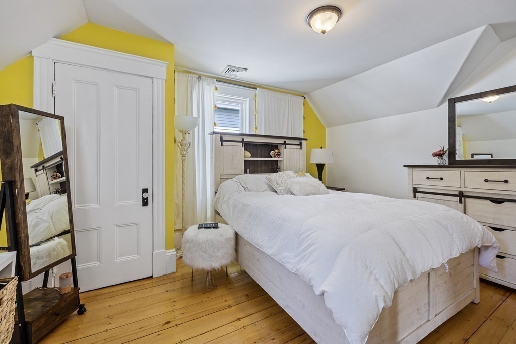 35 Jackson Street Saugus, MA 01906 - Photo 20 of 26 a bedroom with a bed and a flat tv screen on dresser