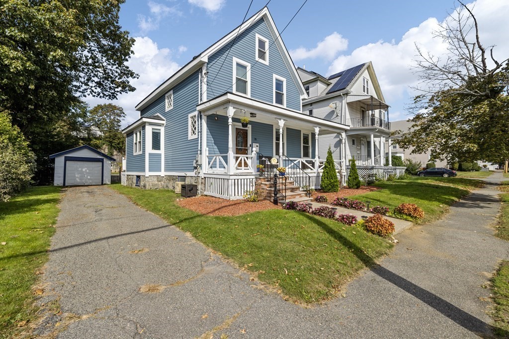 35 Jackson Street Saugus, MA 01906 - Photo 2 of 26 a front view of a house with a yard table and chairs