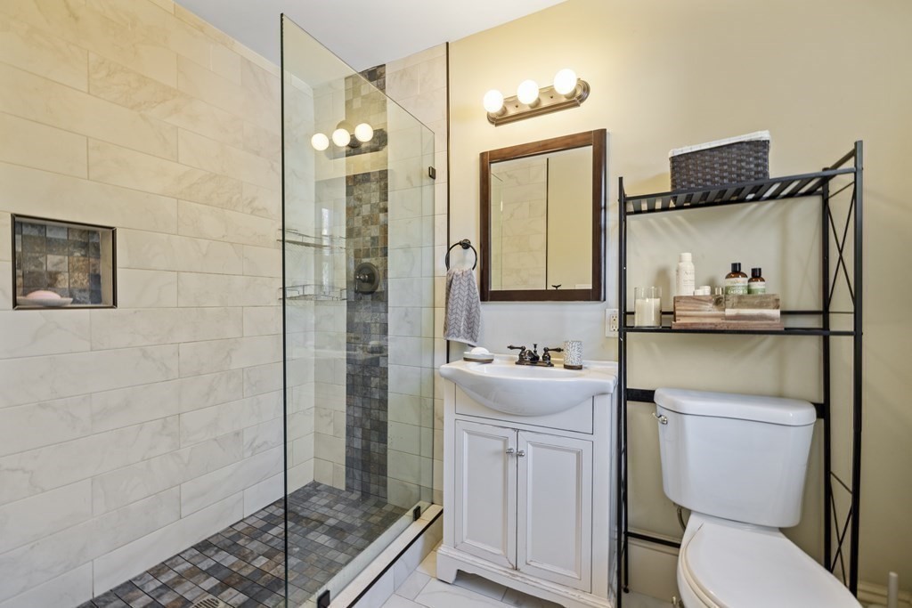 35 Jackson Street Saugus, MA 01906 - Photo 23 of 26 a bathroom with a sink a toilet and shower