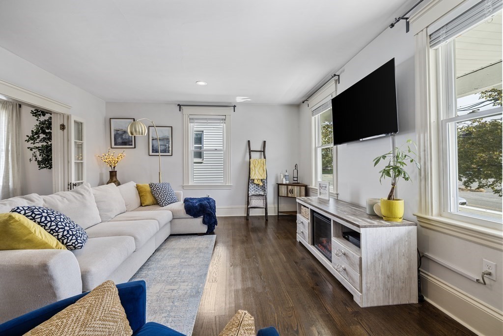 35 Jackson Street Saugus, MA 01906 - Photo 4 of 26 a living room with furniture flat screen tv and a fireplace