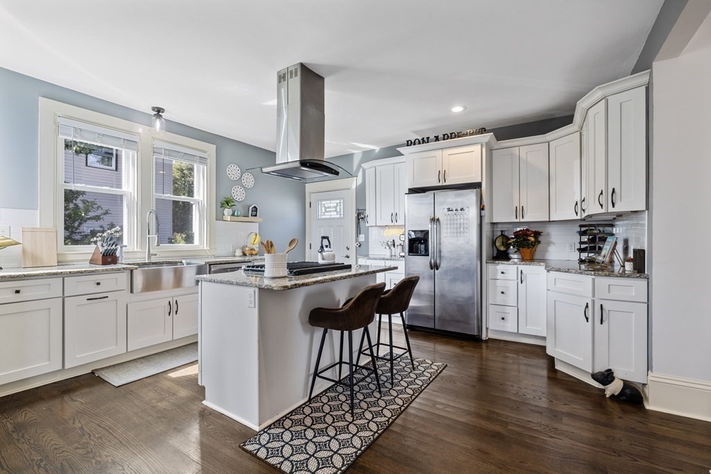 35 Jackson Street Saugus, MA 01906 - Photo 7 of 26 a kitchen with white cabinets and stainless steel appliances