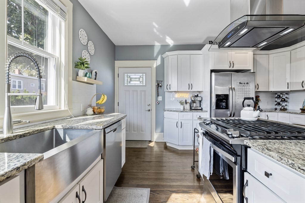 35 Jackson Street Saugus, MA 01906 - Photo 9 of 26 a kitchen with stainless steel appliances granite countertop a sink stove and refrigerator