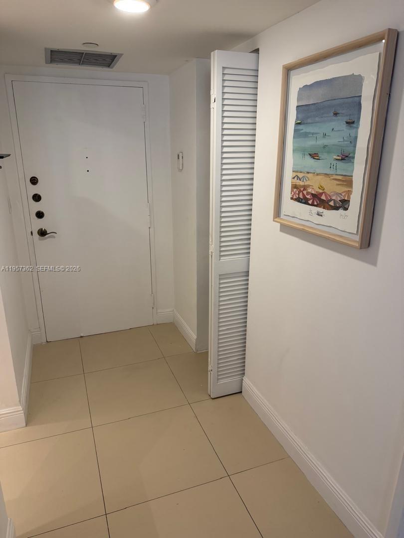 1865 Brickell Avenue, Unit A810 Miami, FL 33129 - Photo 11 of 24 a view of an empty room with closet