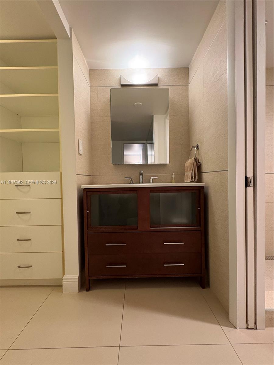 1865 Brickell Avenue, Unit A810 Miami, FL 33129 - Photo 18 of 24 a bathroom with a sink and a mirror