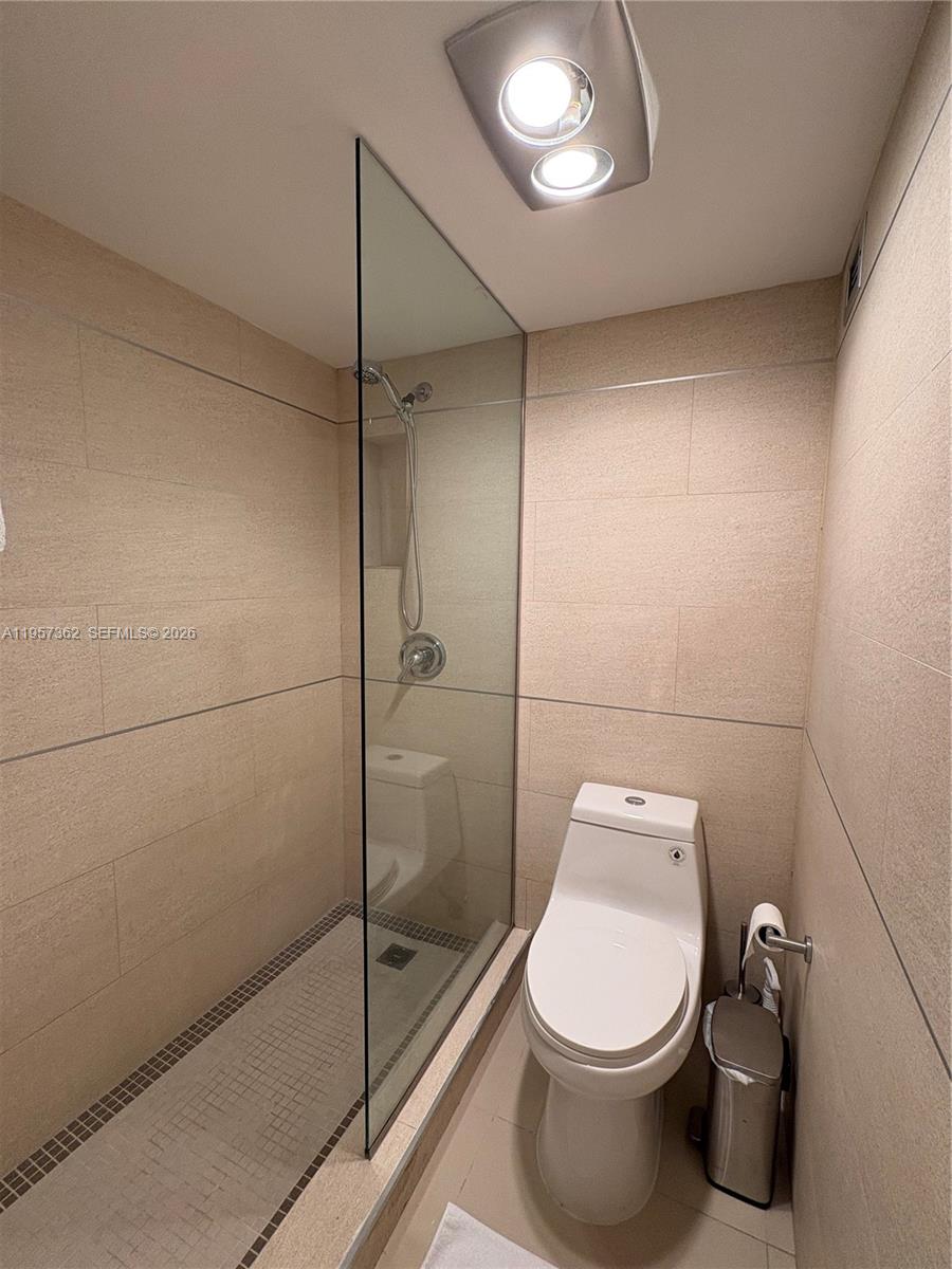 1865 Brickell Avenue, Unit A810 Miami, FL 33129 - Photo 19 of 24 a bathroom with a toilet and a shower