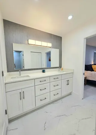 a bathroom with a sink a mirror and a bathtub
