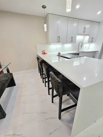 a large kitchen with a table and chairs