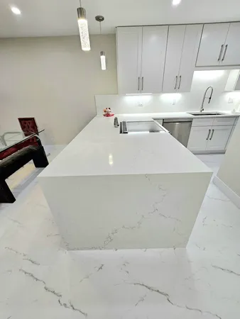 a kitchen with sink a stove and cabinets