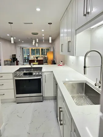 a living room with furniture and kitchen view