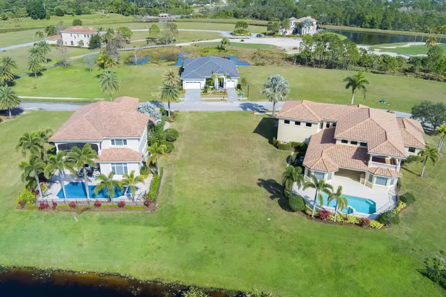 an aerial view of a house with outdoor space and lake view